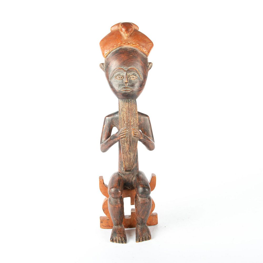 Appraisal: HAND CARVED AFRICAN FIGURAL SCULPTURE SEATED MAN Solid hard wood