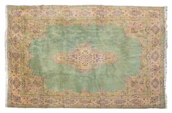 Appraisal: A Kirman Wool Carpet having a foliate center medallion on