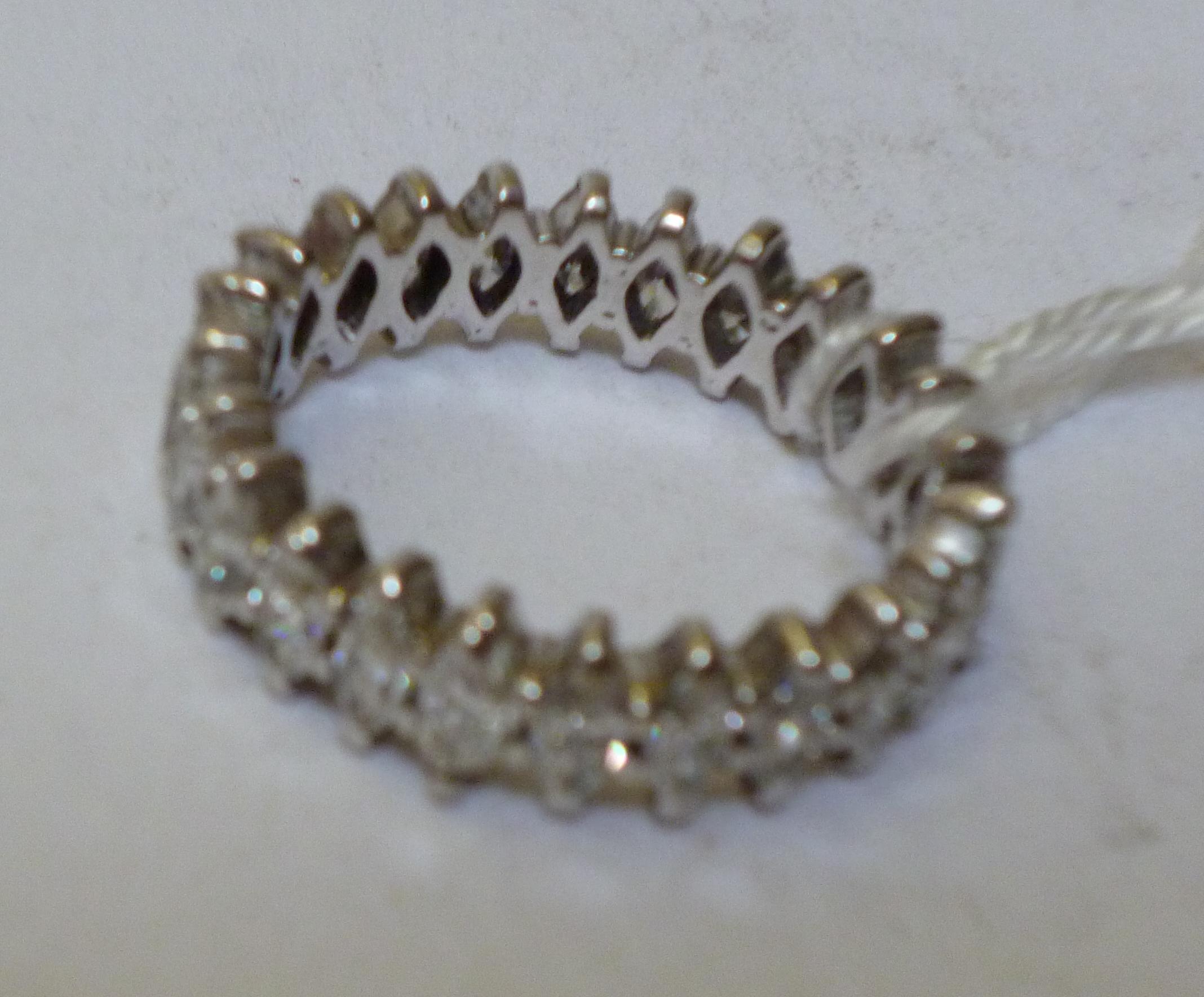 Appraisal: A DIAMOND ETERNITY RING claw set with twenty four marquise