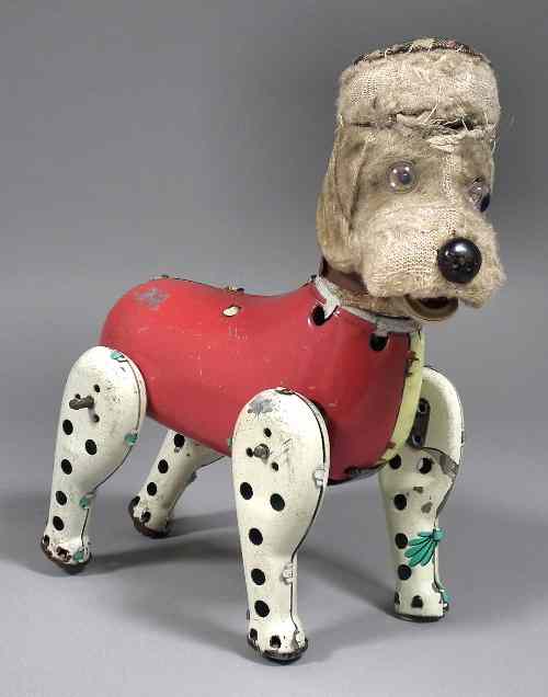 Appraisal: A th Century Japanese tinplate clockwork dog toy with ''light