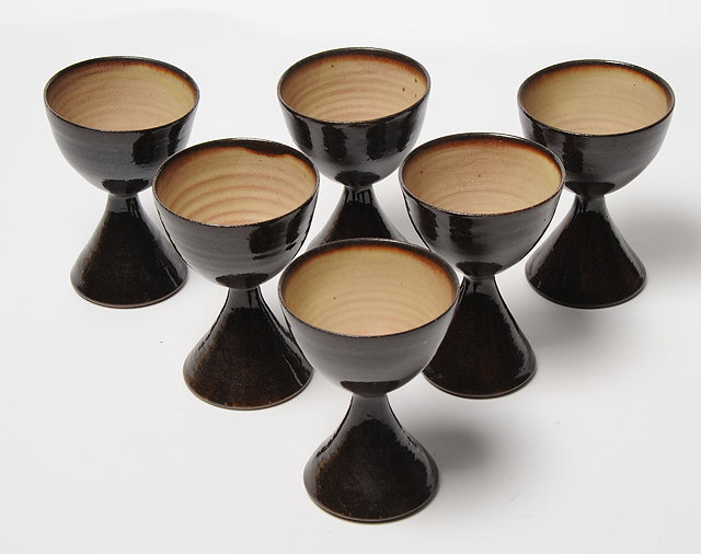 Appraisal: A GROUP OF SIX IRISH BROWN GLAZED TERRYBAUN POTTERY GOBLETS