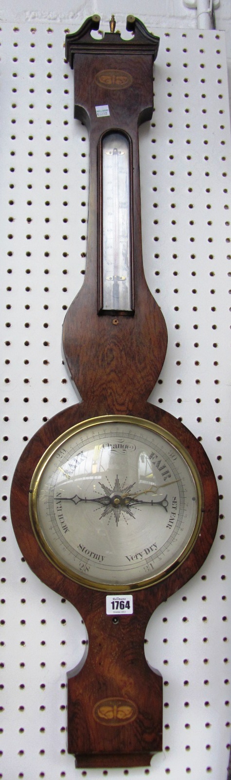 Appraisal: A Victorian rosewood wheel barometer with broken arch pediment over