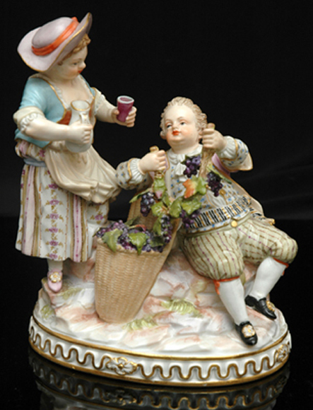 Appraisal: A MEISSEN PORCELAIN FIGURE GROUP Modelled as a seated gentleman