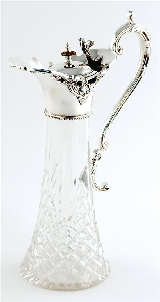 Appraisal: Silver-mounted crystal ewer shaped spout and ornate cover supporting scrolling