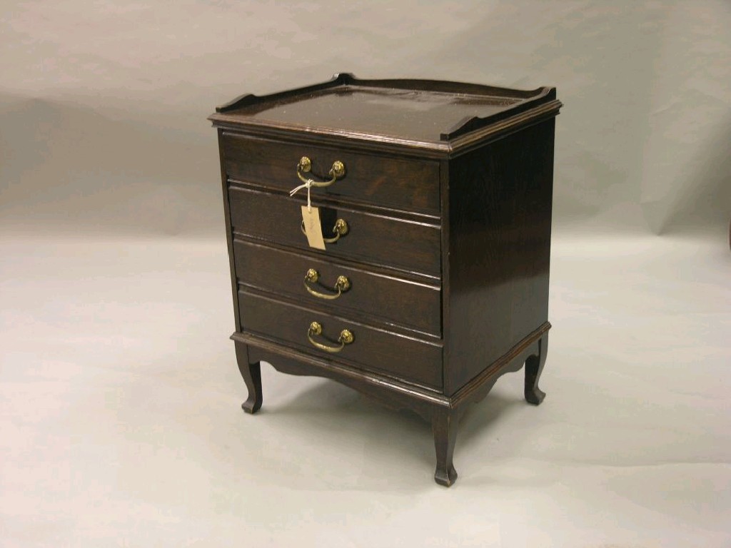 Appraisal: A solid dark oak music chest tray top above four-front