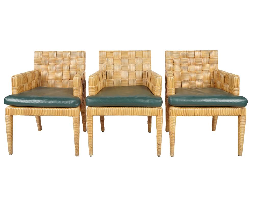 Appraisal: THREE DONGHIA WICKER DINING CHAIRSeach with green leather removable cushion