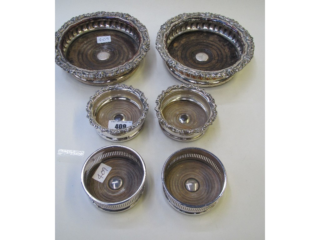 Appraisal: Lot comprising three pairs of silver plated wine coasters