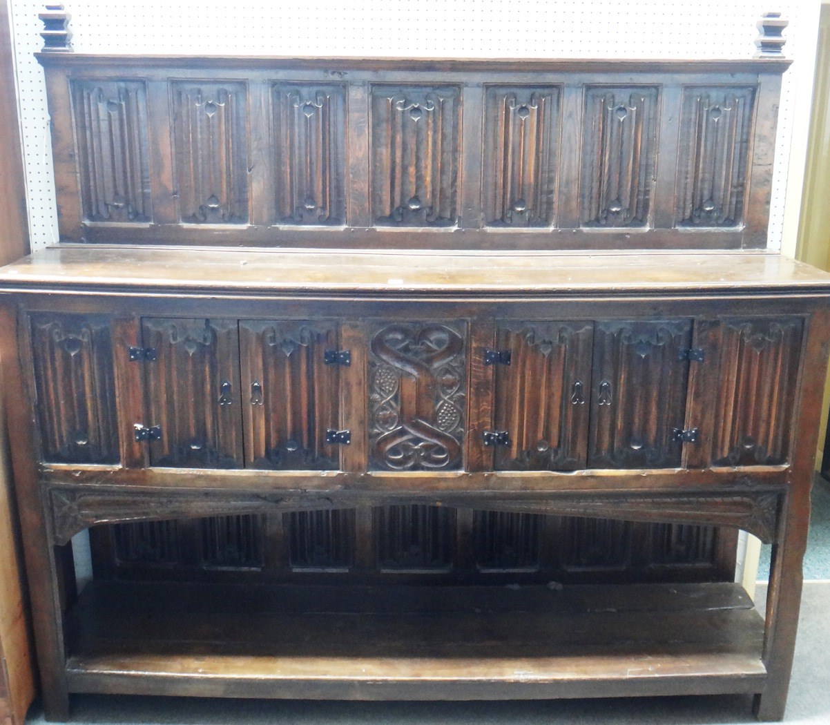 Appraisal: A th style oak dresser with linen fold carved back