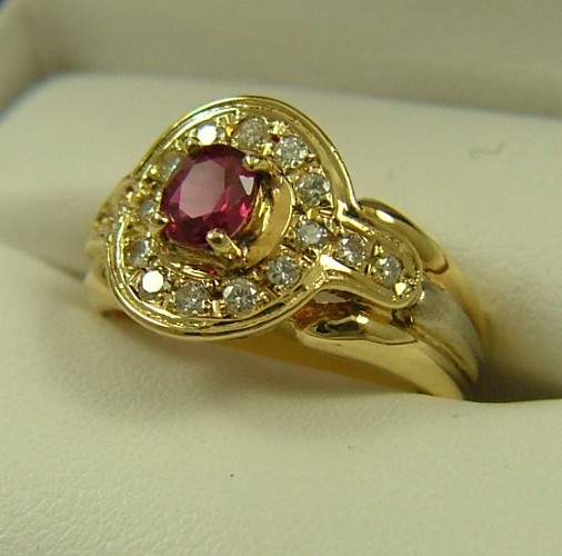 Appraisal: RUBY DIAMOND AND FOURTEEN KARAT GOLD RING centering an oval-cut