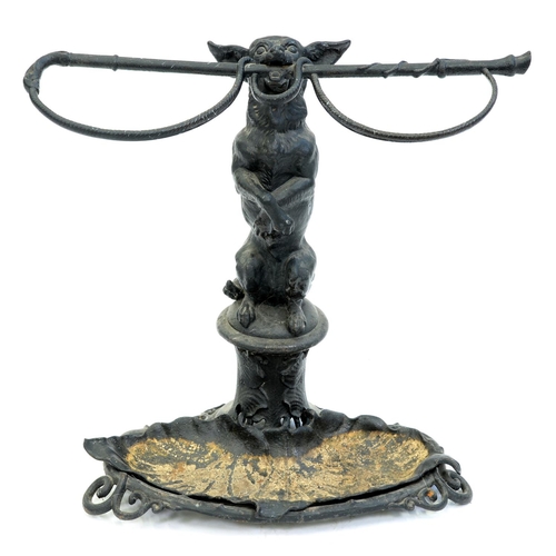 Appraisal: A cast iron begging dog and riding crop umbrella stand