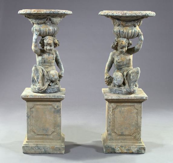 Appraisal: Pair of Cast Cement Garden Urns-on-Pedestals each depicting a crouching