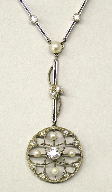 Appraisal: Attractive white gold diamond and pearl set circular pierced pendant