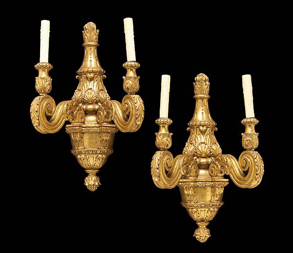 Appraisal: A pair of Italian Baroque style two-light giltwood wall lights