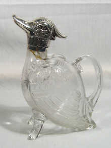 Appraisal: A silver mounted glass claret jug in the form of