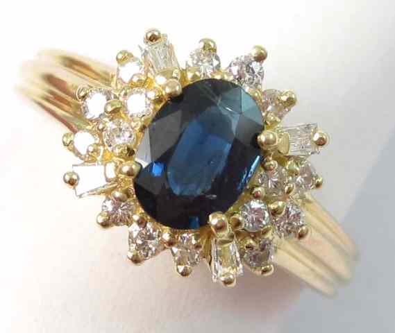 Appraisal: SAPPHIRE DIAMOND AND FOURTEEN KARAT GOLD RING round-cut and baguette-cut