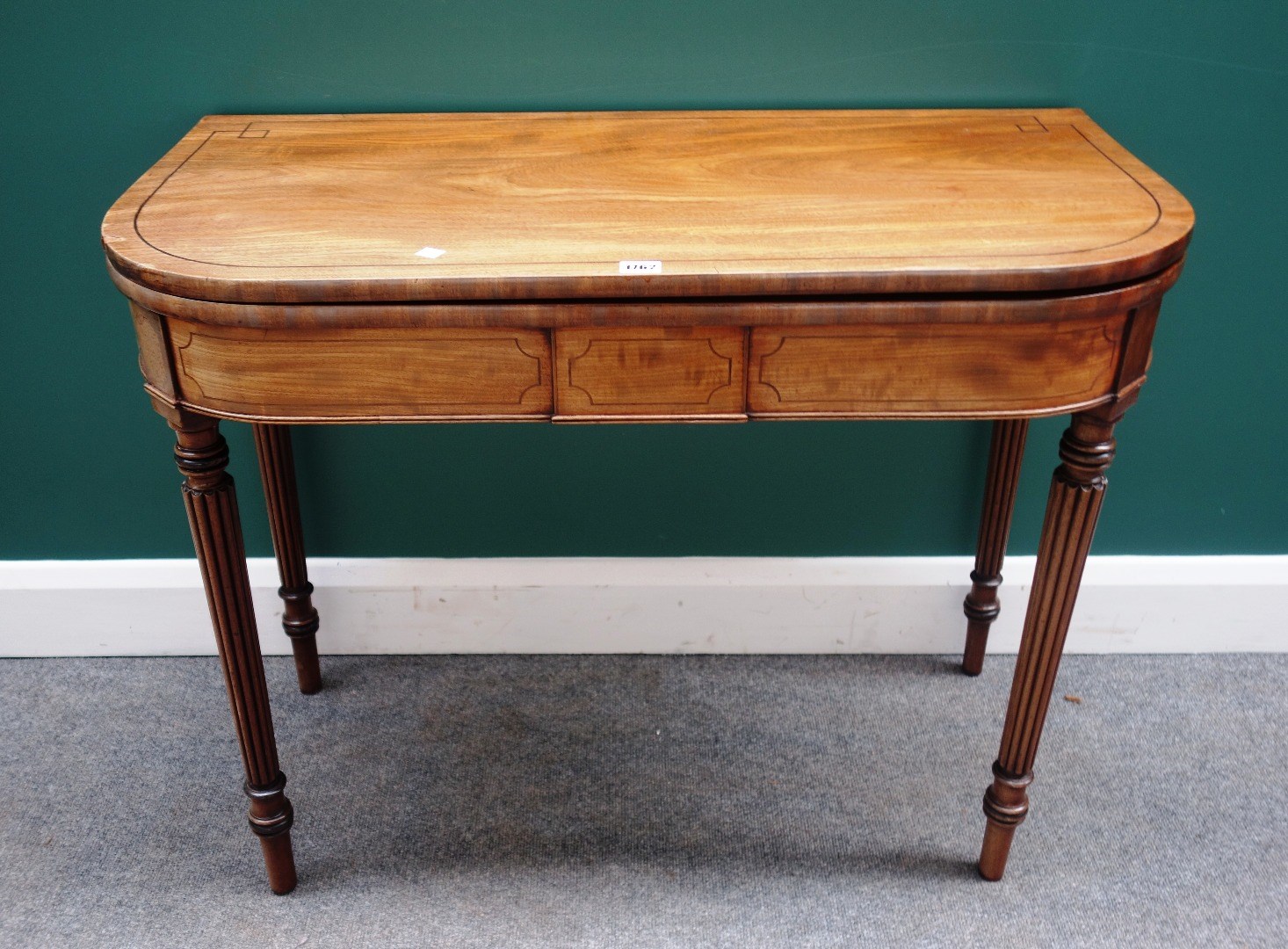 Appraisal: A Regency inlaid mahogany tea table on tapering reeded supports