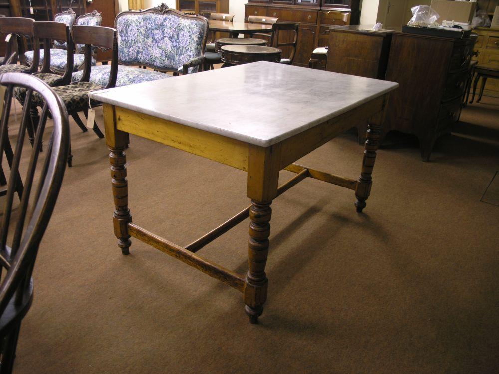 Appraisal: A Victorian varnished pine kitchen table with white marble top