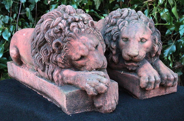 Appraisal: A PAIR OF CAST COMPOSITE RECUMBENT LIONS after Canova resting