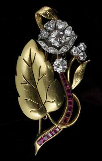 Appraisal: A diamond and ruby set foliate spray brooch the flowerhead