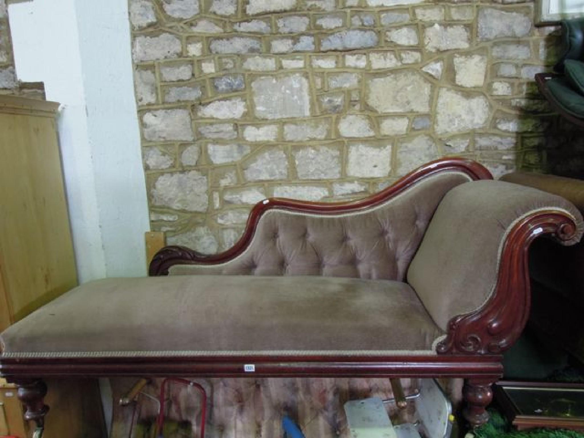 Appraisal: A Victorian mahogany chaise lounge with upholstered seat scrolled head