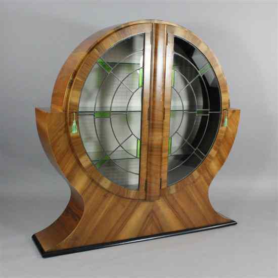 Appraisal: An Art Deco walnut display cabinet of stylised circular form