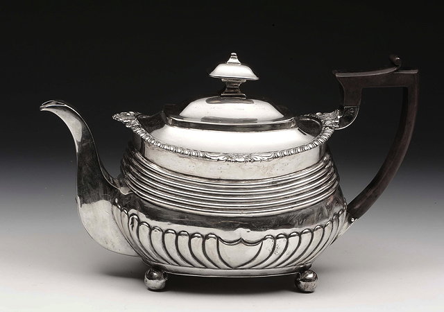 Appraisal: A GEORGE III SILVER TEAPOT oval shaped with fluted lower