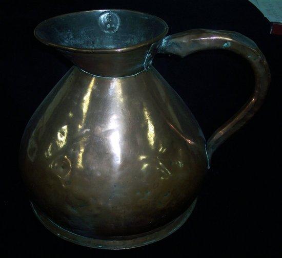 Appraisal: A large copper rum jug on a skirt base cm