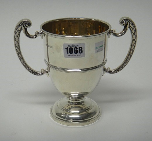 Appraisal: A silver twin handled trophy cup presentation inscribed on a