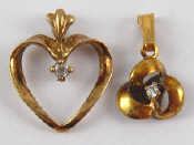 Appraisal: A mixed lot comprising two carat gold diamond pendants gms