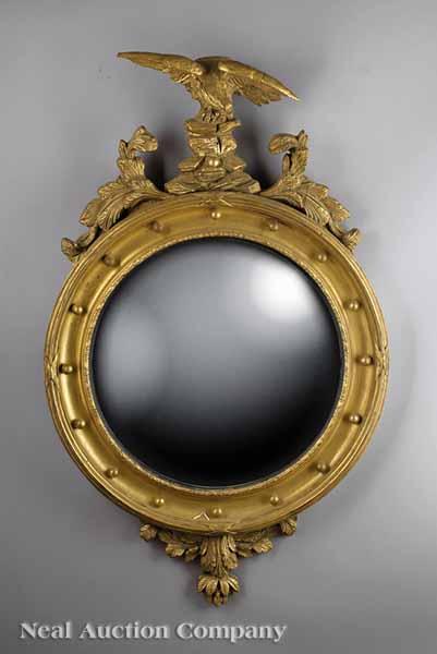 Appraisal: A Regency-Style Giltwood Bullseye Mirror having an eagle atop rockwork