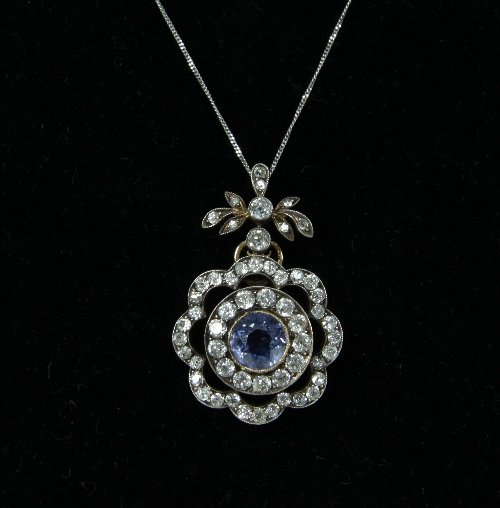 Appraisal: A sapphire and diamond pendant centred by a pale blue