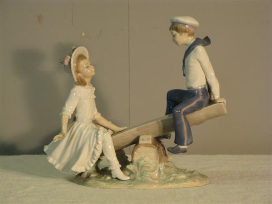 Appraisal: Lladro figure of a boy and girl on a swing