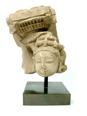 Appraisal: An Indian greystone fragment carved with a female head wearing