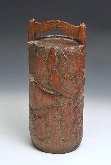 Appraisal: A JAPANESE WOOD CYLINDRICAL CONTAINER with carved lily pads and