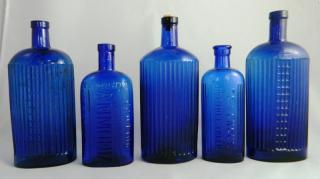 Appraisal: Poison cobalt bottles Poison- cobalt embossed with vertical ribbing ''