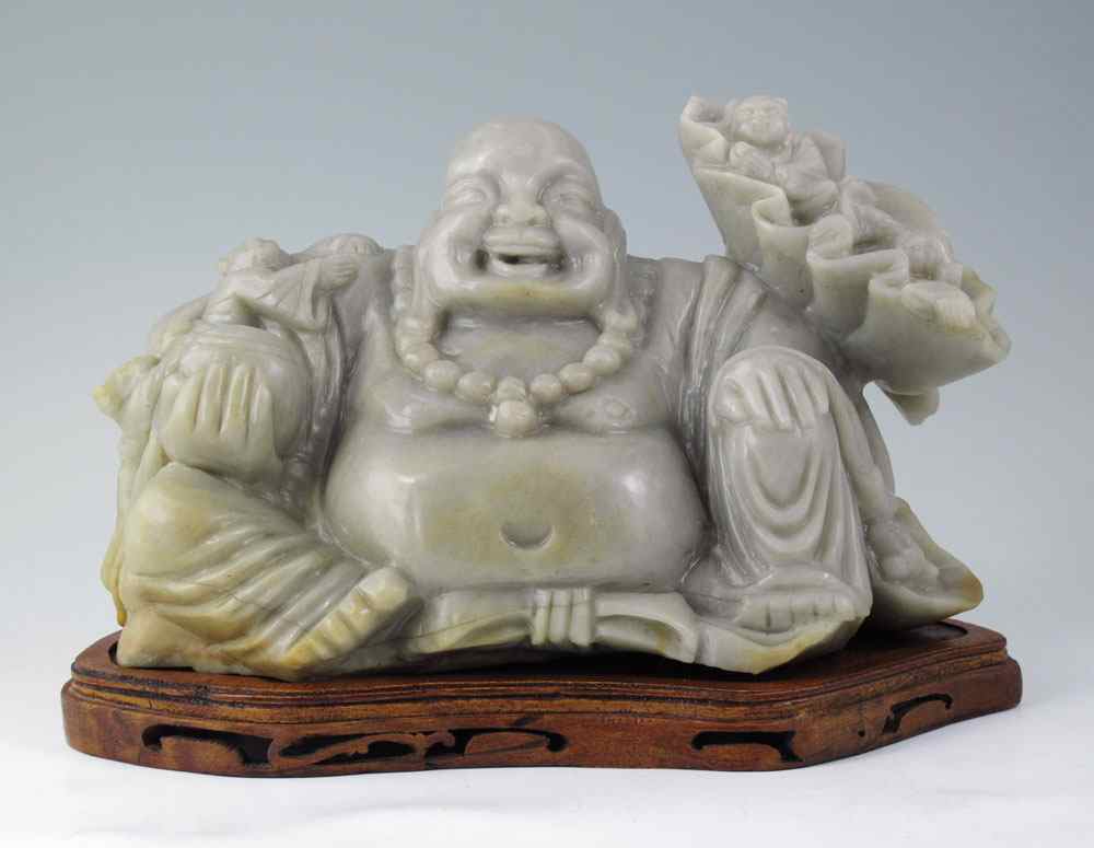 Appraisal: LARGE CARVED SOAPSTONE HAPPY BUDDHA Seated Buddha with figures and