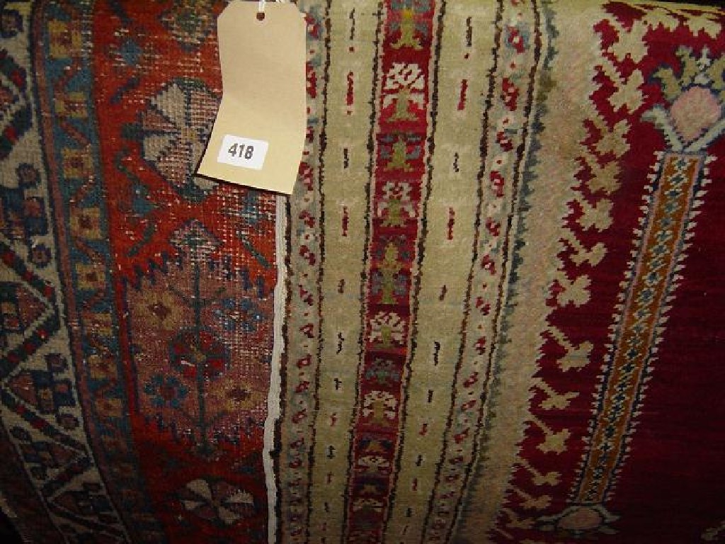 Appraisal: A red ground Eastern wool prayer rug with repeating borders