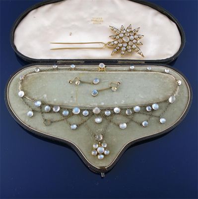 Appraisal: A necklace mounted with moonstone cabochons fitted case and a