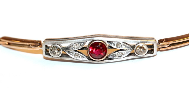 Appraisal: A DIAMOND AND SYNTHETIC RUBY BRACELET central panel set with