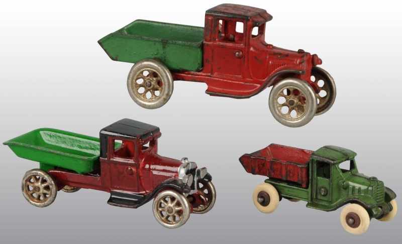 Appraisal: Lot of Cast Iron Arcade Dump Truck Toys Description American