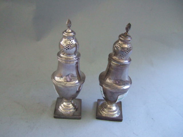 Appraisal: A pair of silver pepperettes each of baluster form and