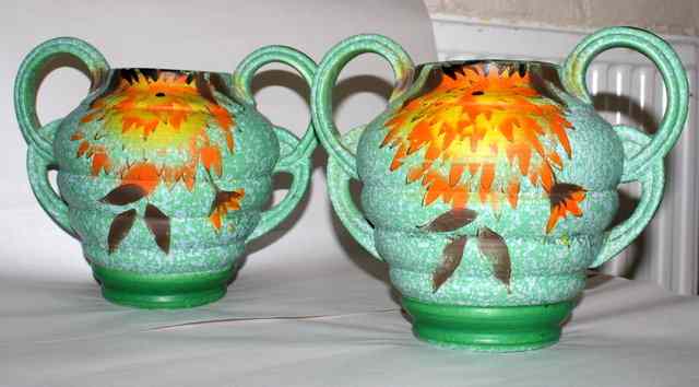 Appraisal: A PAIR OF ART DECO POLYCHROME POTTERY TWO HANDLED JUGS