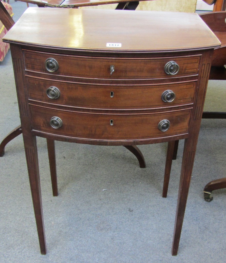 Appraisal: A George III mahogany three drawer side table on tapering