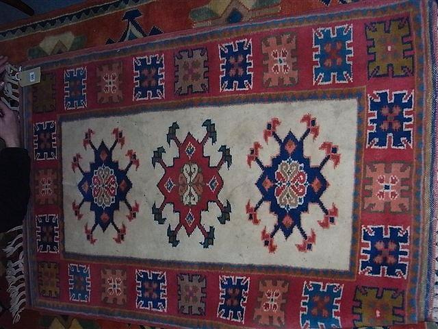 Appraisal: A TURKISH SMALL RUG with three central medallions and geometrical