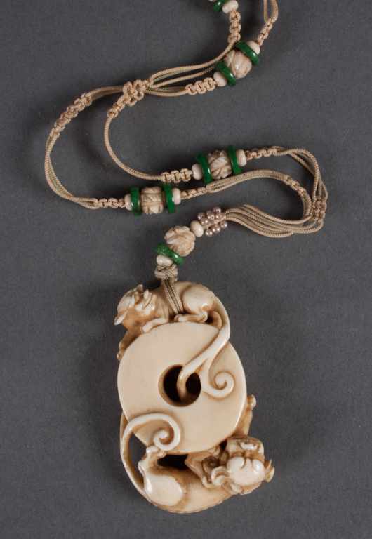 Appraisal: Chinese carved ivory pendant th Century modeled as two foo