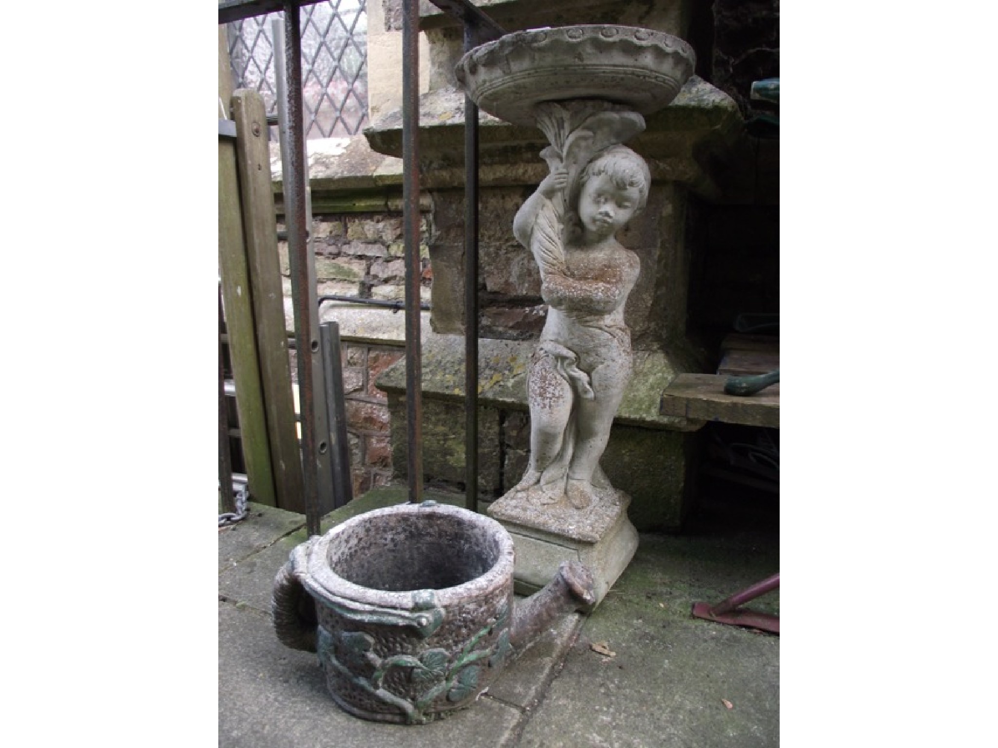 Appraisal: A contemporary cast composition stone bird bath in the form