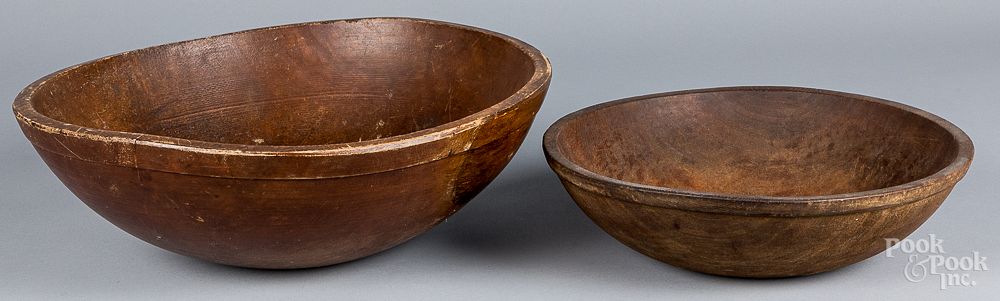 Appraisal: Two large turned wooden bowls th c Two large turned