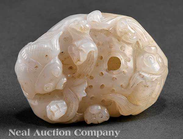 Appraisal: A Chinese White Jade 'Lotus Pond' Pebble carved as pierced