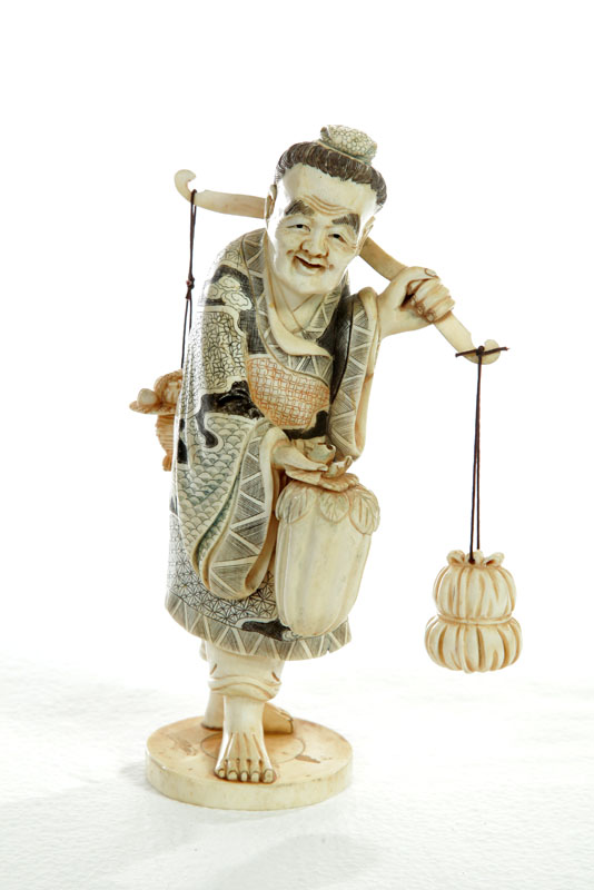 Appraisal: IVORY FIGURE Japan st half- th century Man carrying bags