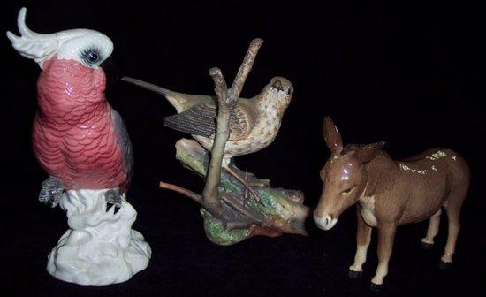 Appraisal: A Beswick cockatoo a Beswick donkey and a Coalport songthrush